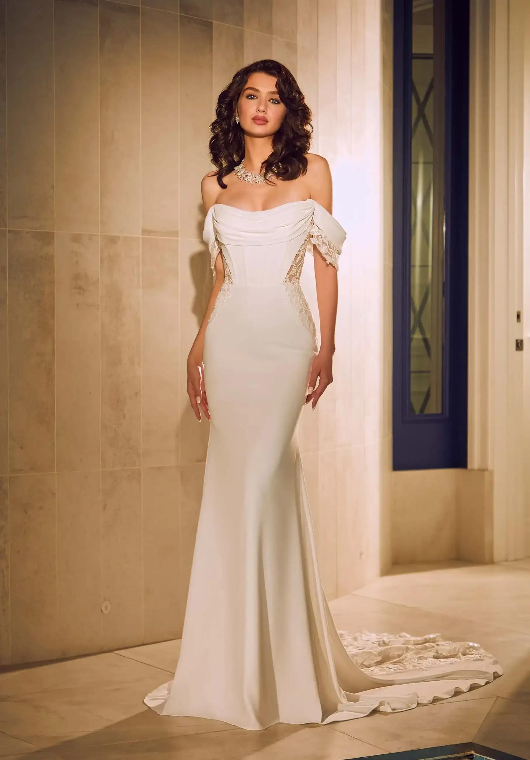 Model wearing a white gown by Amy&Eve