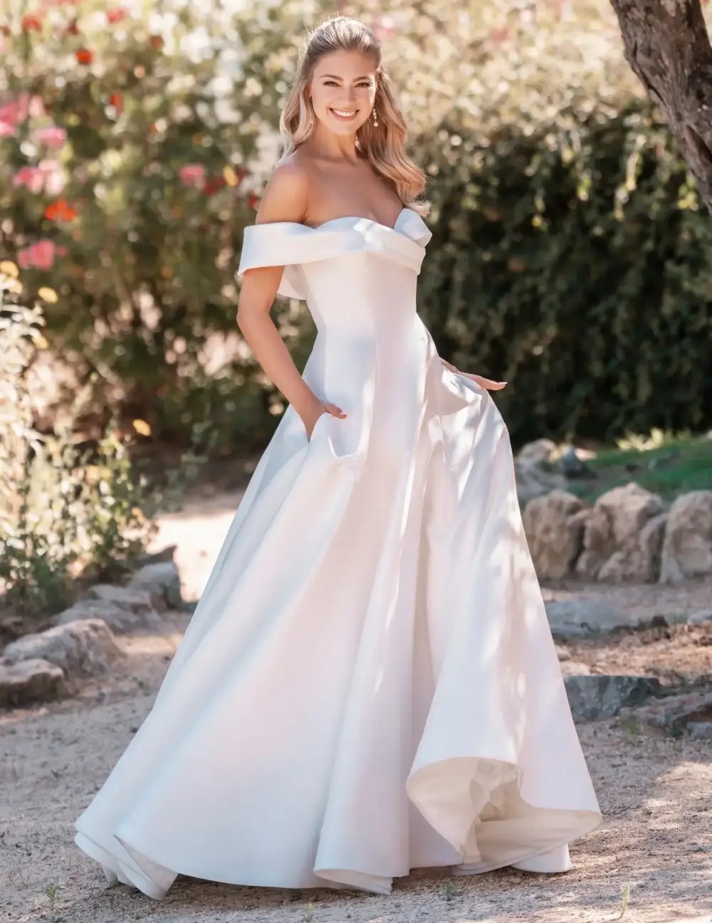 Model wearing a white gown by Allure