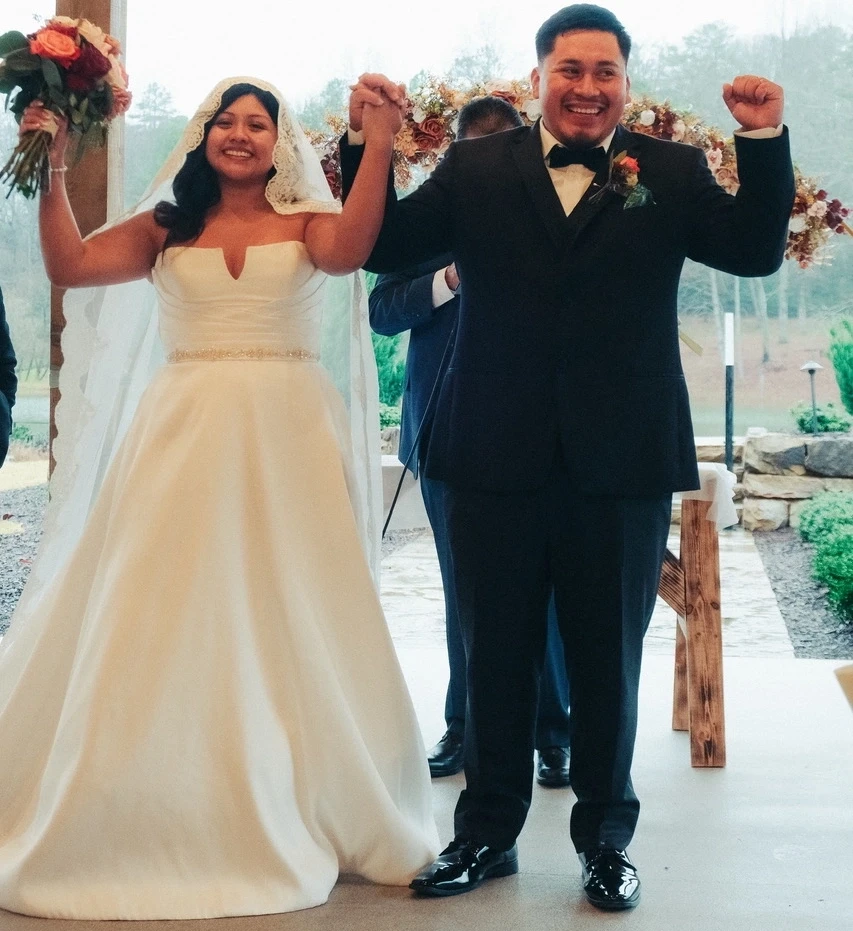 Сouple wearing a white gown and a black suit