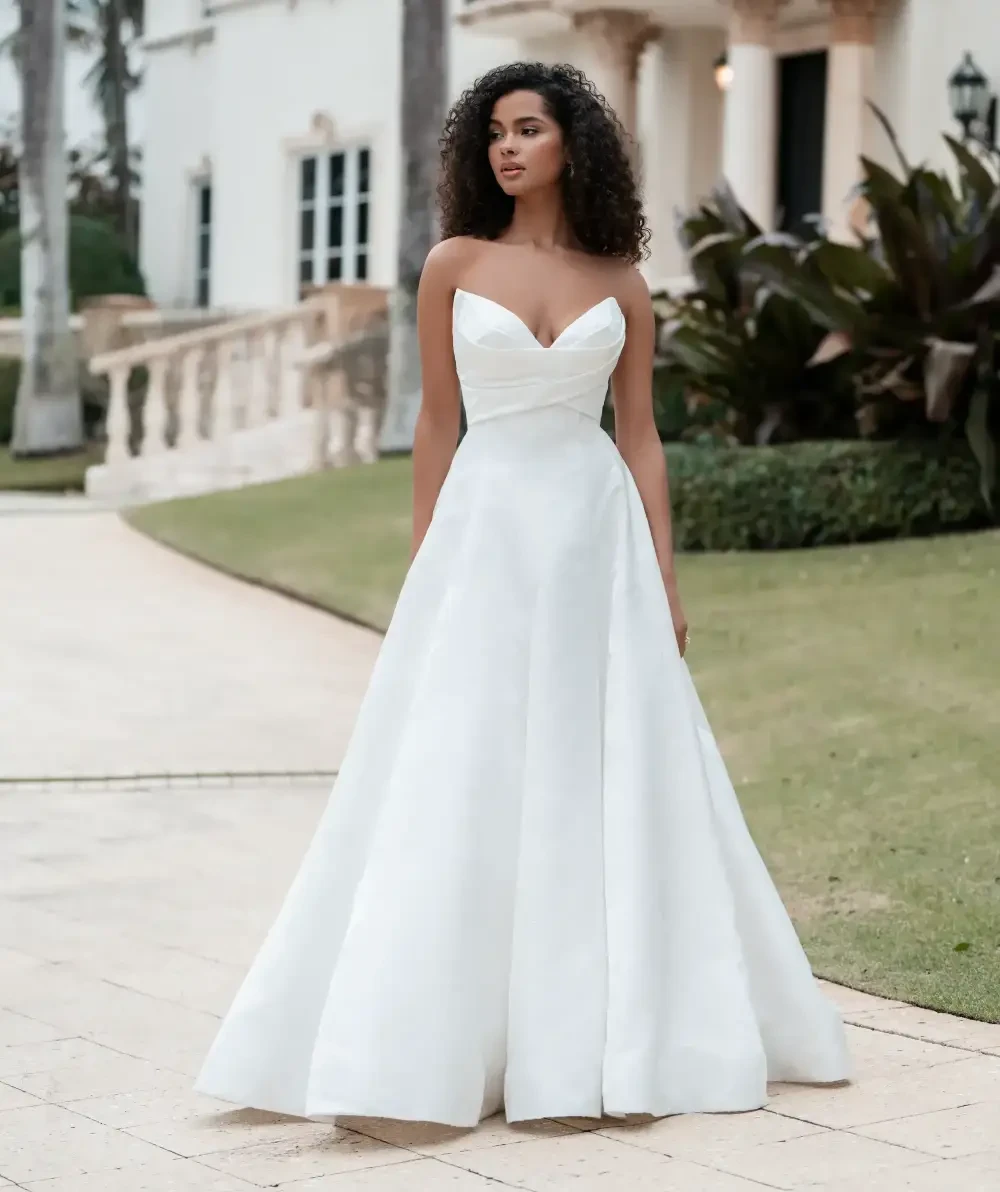 Model wearing a white gown by Allure Bridals