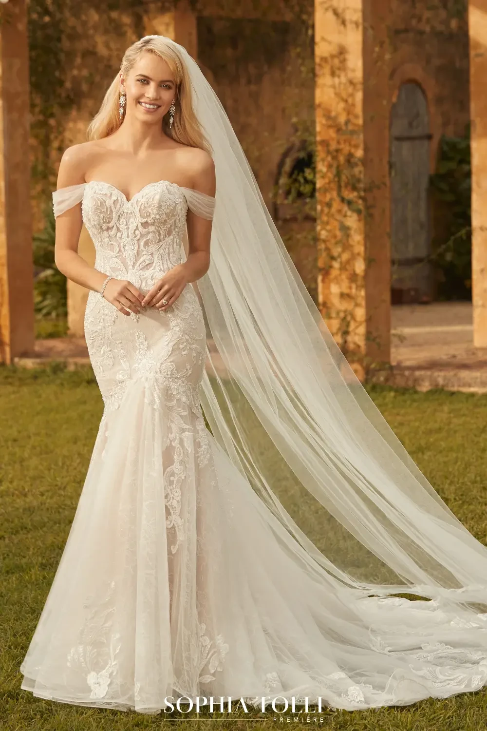 Model wearing a white gown by Sophia Tolli Premiere
