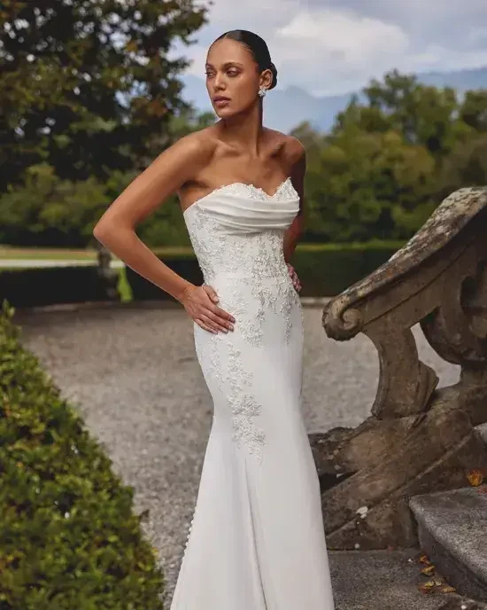 Model wearing a white gown by Justin Alexander