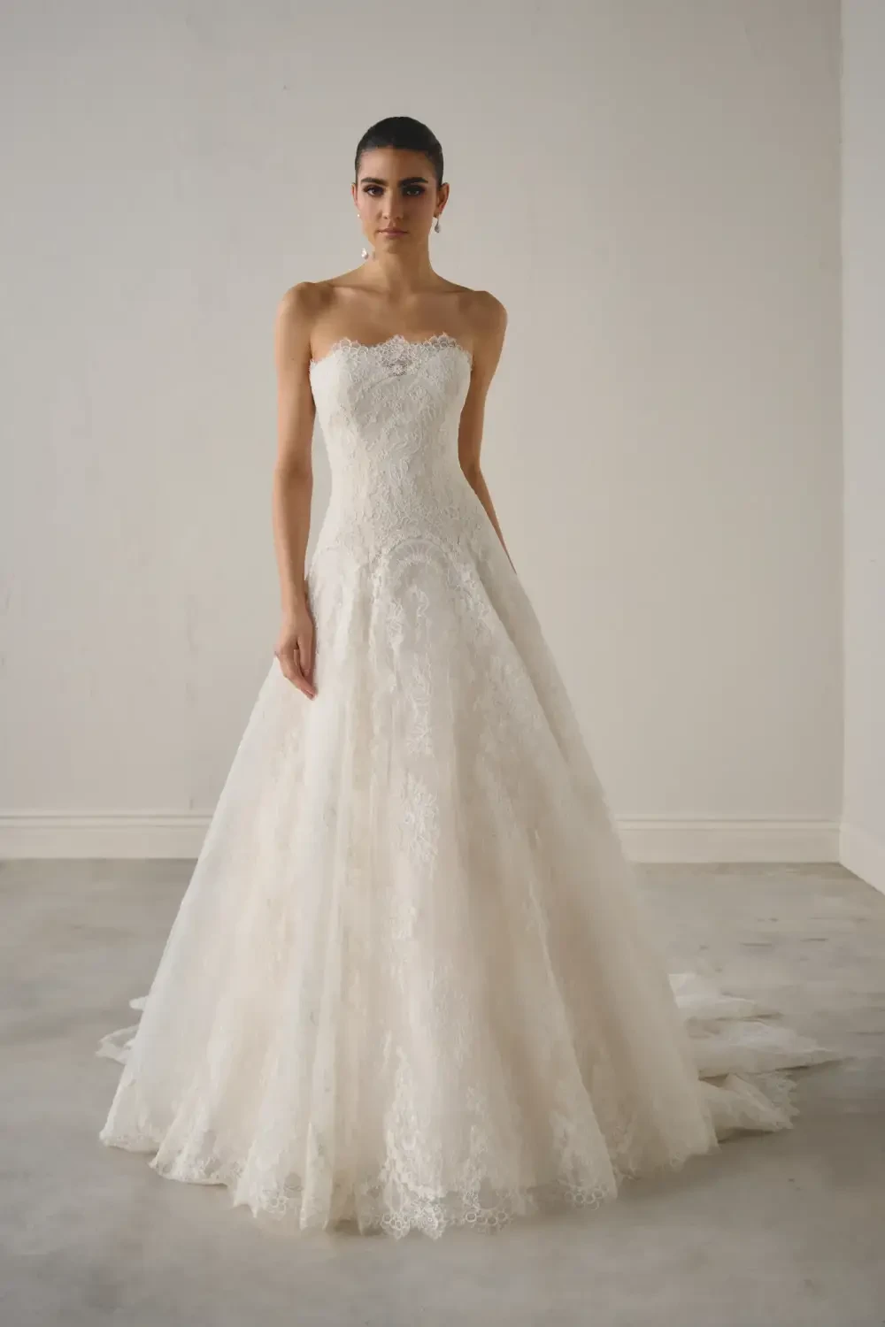 Model wearing a white gown by Justin Alexander Signature