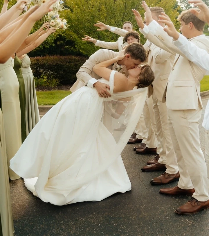 Сouple wearing a white gown and a beige suit