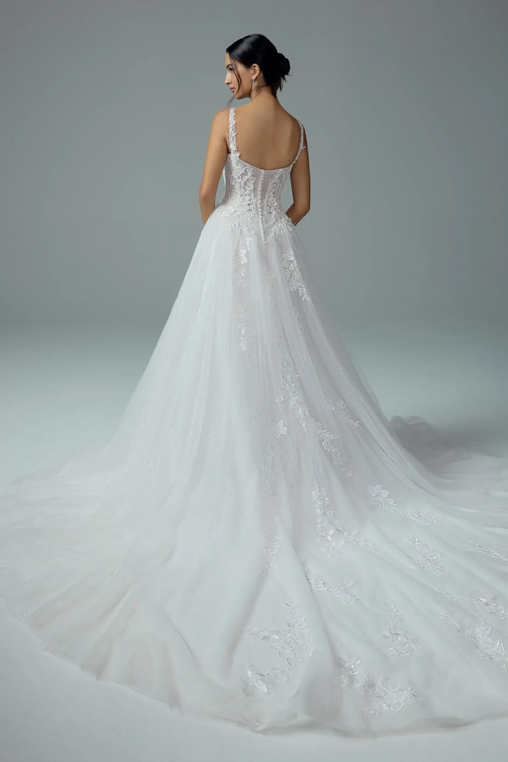 model is wearing a sleeveless basque waist wedding dress