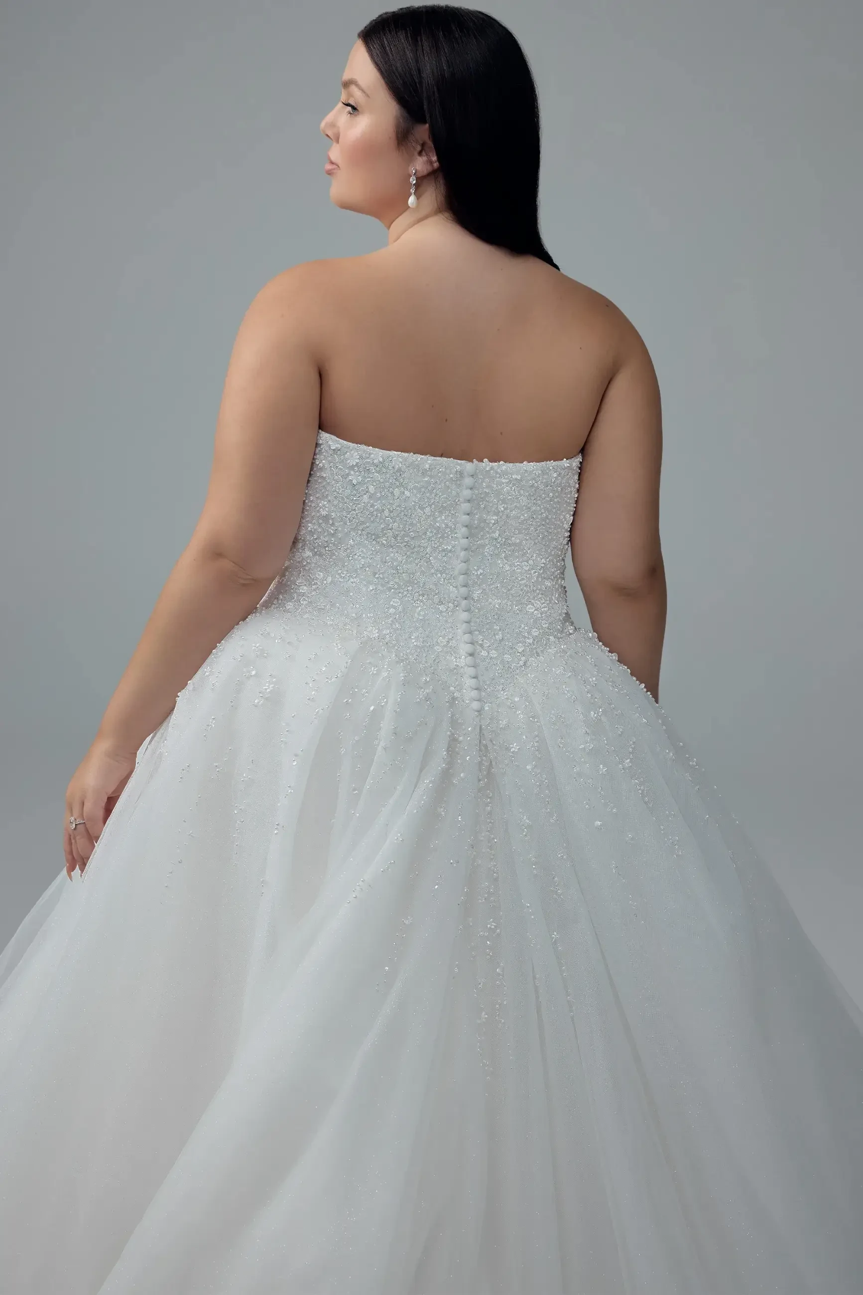 model is wering a strapless a-line wedding dress
