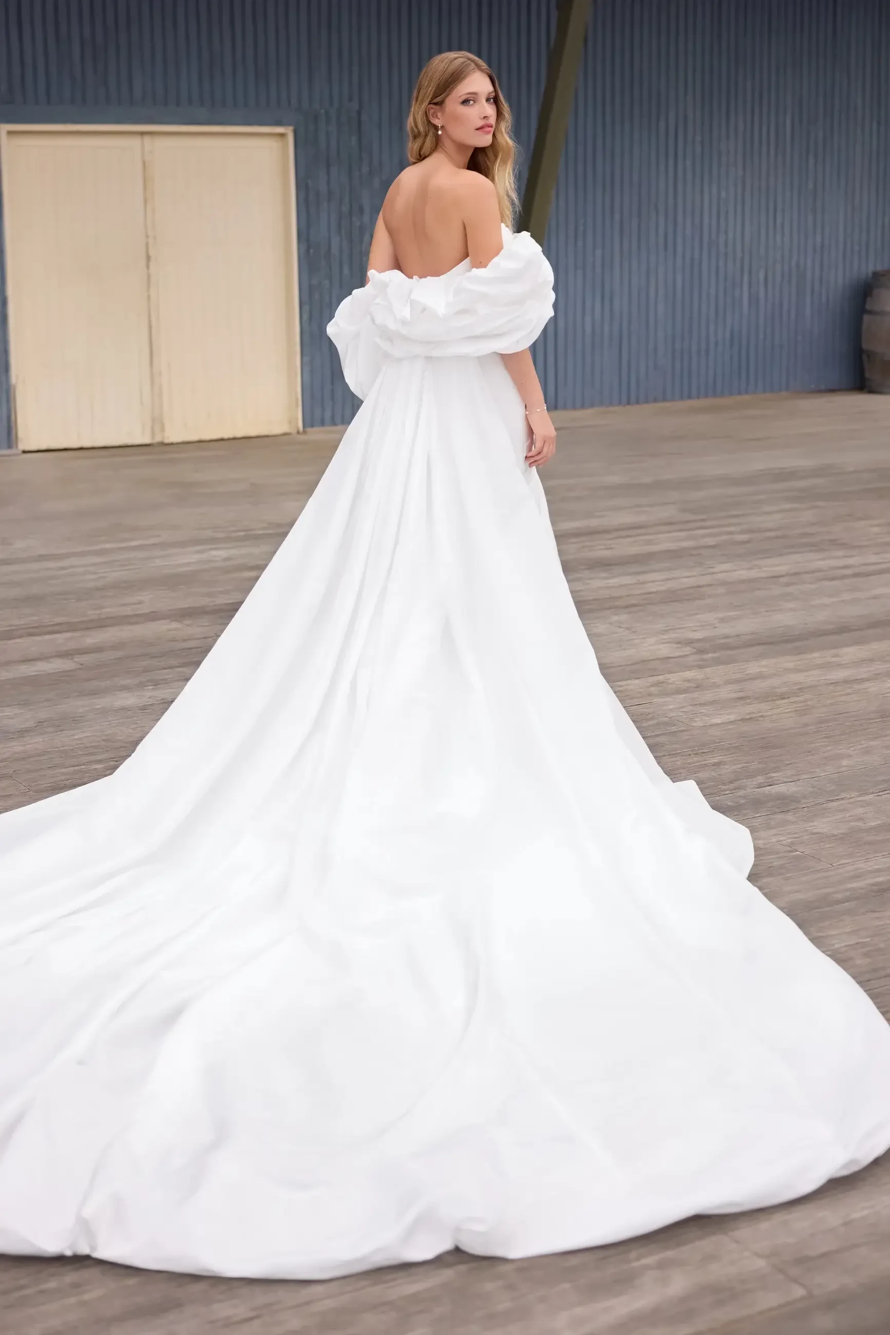 model is wearing an a-line wedding dress with detachable cape
